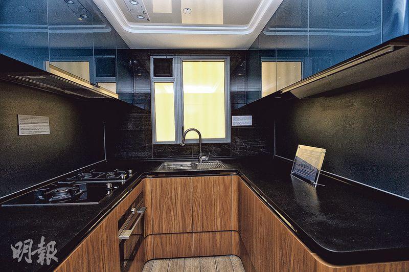 廚房採用灰藍色光面櫥櫃，儲物空間充裕。