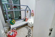 另一間睡房佈置成兒童睡房，擺放屋形框架的兒童牀、玩偶及玩具。（楊柏賢攝）