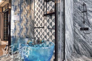 主人浴室設計時尚，採特色雲石牆之餘，更罕有地採用藍色透明橢圓形浴缸。
