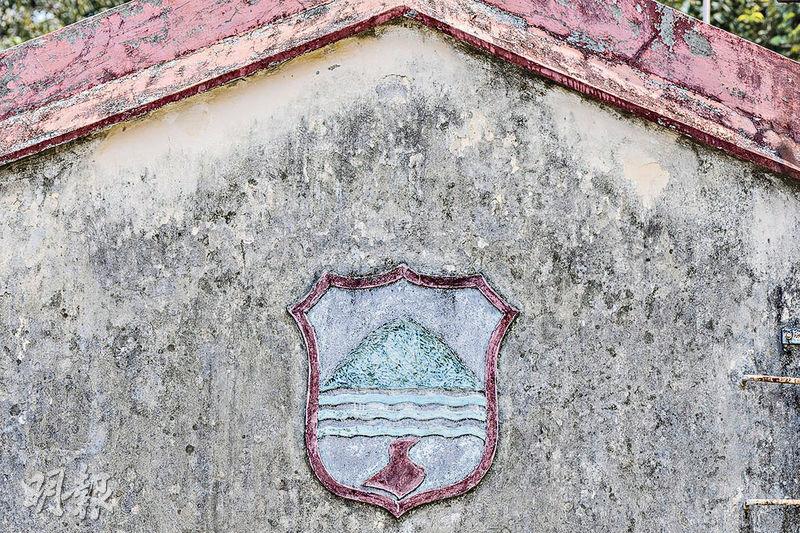牆上校徽--有山有水有路的校徽，濃縮了無數漁民子弟成長的故事。（馮凱鍵攝）