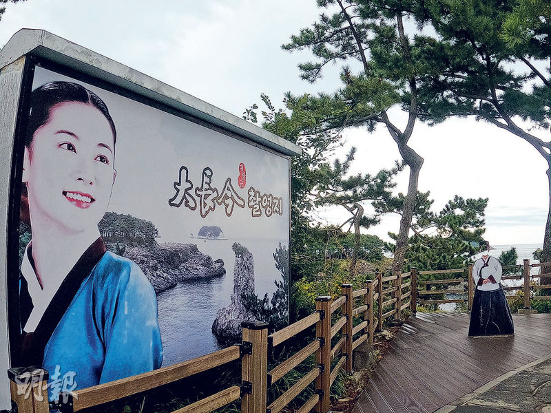 韓劇《大長今》曾在將軍岩取景，圍欄邊放有大長今紙牌公仔供遊人打卡。（蔡朗清攝）