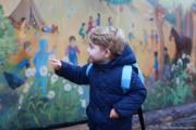 2016年1月6日，喬治小王子走在幼兒園門外，對牆上畫作感到好奇。（The British Monarchy fb圖片）