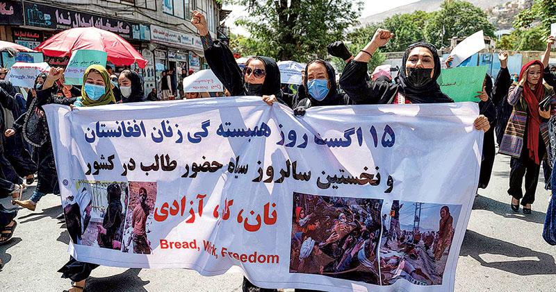 阿富汗一些婦女上周六在首都喀布爾遊行爭取婦女權益，呼叫要「麵包、工作、自由」的口號。（法新社）