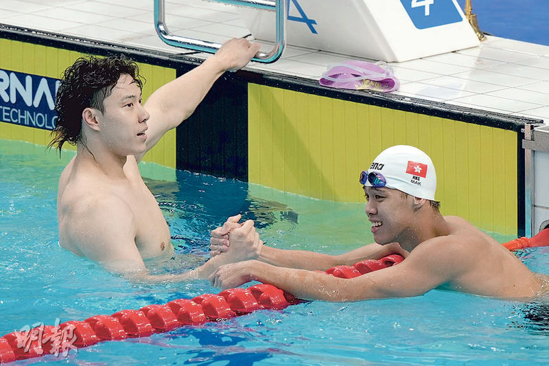 港隊小將麥世霆（右）在200米蛙泳決賽與國家隊星將覃海洋（左）同場較量，兩人賽後握手惺惺相惜。（鍾林枝攝）
