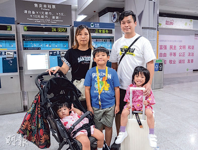 港人梁氏夫婦一家五口在落馬洲過關到福田，推嬰兒車又拖着一個行李箱，在地鐵站購票準備到深圳北。梁太（後排左一）說已預約酒店，趁今次長假期到深圳北遊玩兩日一夜。（朱安妮攝）