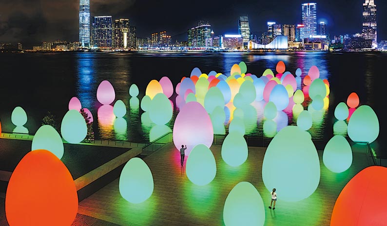 國際藝術團隊teamLab打造嘅發光蛋狀物（ovoid）藝術裝置，將由中環海濱長廊一帶延伸到維港海面，裝置仲會隨住同觀眾嘅互動變色。圖中構想圖顯示裝置最少有8種顏色。（康文署圖片）